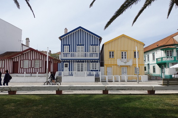 Wondering what to see in Aveiro? Visit the Aveiro beaches like Costa Nova. Costa Nova is famous for its colorful striped houses pictured here.